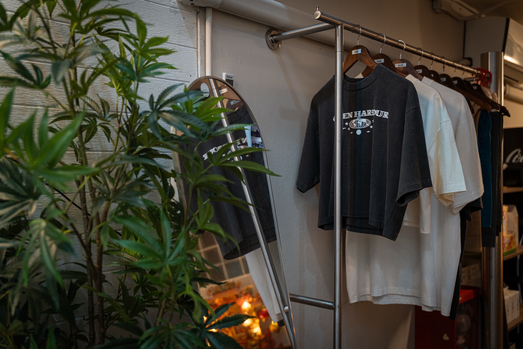Green Harbour branded t-shirts on a clothing rack